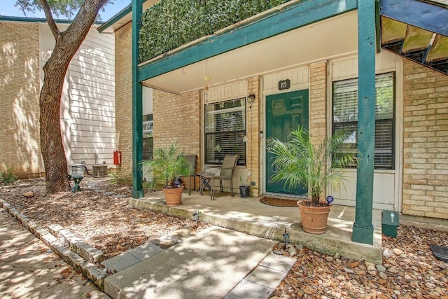 1624 Aquarena Springs Dr Unit B115, San Marcos, TX 78666 - view of exterior entry featuring brick siding and a porch
