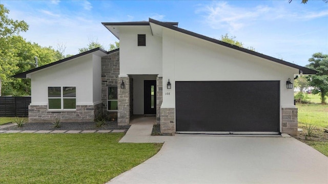 108 Bill St, Elgin, TX 78621 - modern home with stone siding, stucco siding, concrete driveway, an attached garage, and a front yard