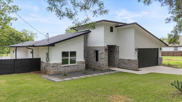 108 Bill St, Elgin, TX 78621 - back of property featuring stone siding, stucco siding, concrete driveway, and an attached garage