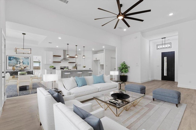 108 Bill St, Elgin, TX 78621 - living room with light wood-type flooring, a chandelier, a ceiling fan, and recessed lighting