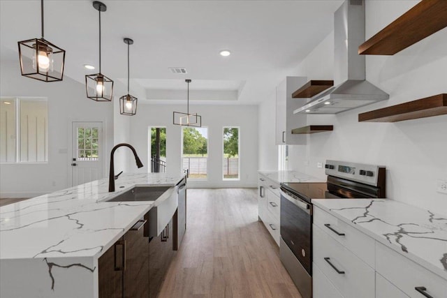 108 Bill St, Elgin, TX 78621 - kitchen with stainless steel appliances, extractor fan, open shelves, light wood-style flooring, and recessed lighting