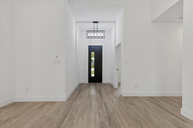 108 Bill St, Elgin, TX 78621 - entrance foyer with light wood-style floors and a chandelier