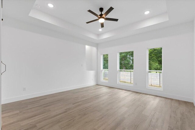 108 Bill St, Elgin, TX 78621 - spare room with a raised ceiling, light wood-type flooring, a ceiling fan, and recessed lighting