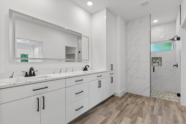 108 Bill St, Elgin, TX 78621 - bathroom featuring double vanity, a shower stall, wood finished floors, and recessed lighting