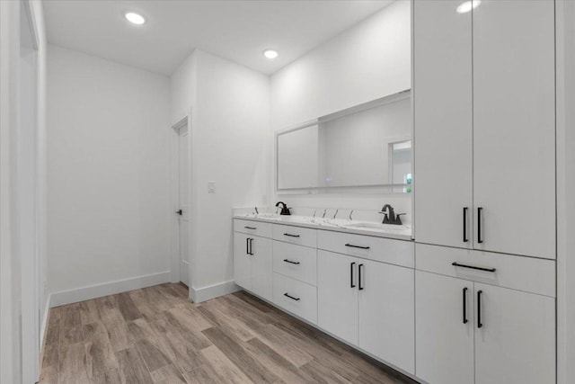 108 Bill St, Elgin, TX 78621 - full bathroom featuring double vanity, wood finished floors, and recessed lighting