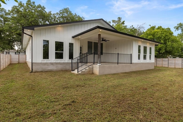 108 Bill St, Elgin, TX 78621 - back of house with ceiling fan, a fenced backyard, and board and batten siding