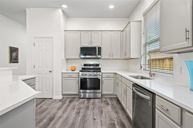 8721 Little Laura Dr, Austin, TX 78757 - kitchen with appliances with stainless steel finishes, wood finished floors, and recessed lighting