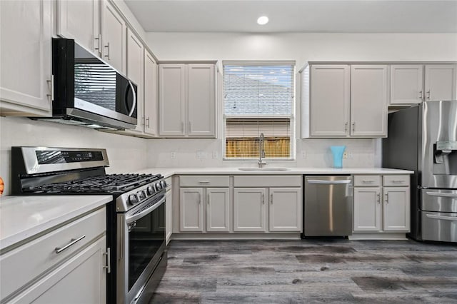 8721 Little Laura Dr, Austin, TX 78757 - kitchen with appliances with stainless steel finishes, dark wood-type flooring, light countertops, and recessed lighting