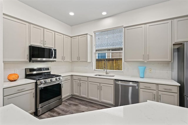 8721 Little Laura Dr, Austin, TX 78757 - kitchen featuring stainless steel appliances, light countertops, dark wood-type flooring, recessed lighting, and gray cabinets