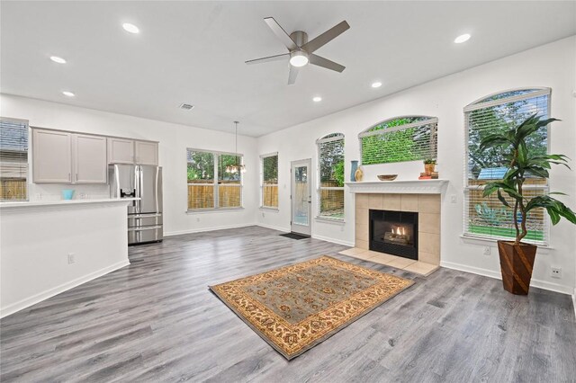 8721 Little Laura Dr, Austin, TX 78757 - unfurnished living room featuring a ceiling fan, wood finished floors, recessed lighting, and a tile fireplace