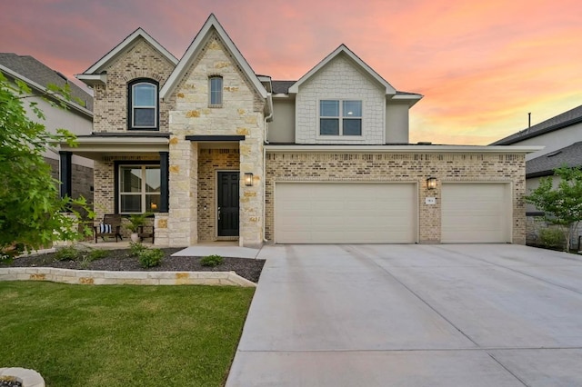 913 Landing Ln, Leander, TX 78641 - french country style house with driveway, brick siding, a front lawn, and an attached garage