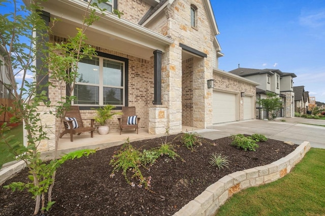 913 Landing Ln, Leander, TX 78641 - view of side of property featuring a porch, concrete driveway, brick siding, stone siding, and a garage