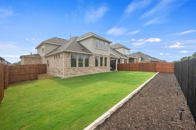 913 Landing Ln, Leander, TX 78641 - back of house featuring a fenced backyard, brick siding, and roof with shingles