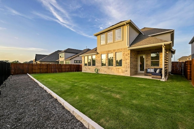 913 Landing Ln, Leander, TX 78641 - rear view of house with a fenced backyard, a patio, a shingled roof, brick siding, and stucco siding