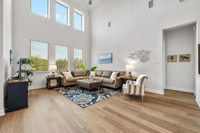 913 Landing Ln, Leander, TX 78641 - living area with a towering ceiling, wood finished floors, and ceiling fan