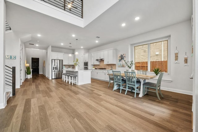 913 Landing Ln, Leander, TX 78641 - dining space featuring light wood-style floors, stairs, and recessed lighting