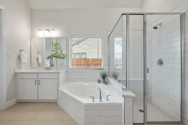 913 Landing Ln, Leander, TX 78641 - bathroom featuring vanity, a garden tub, a shower stall, and tile patterned floors