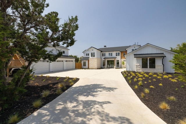 4100 Peak Look Out Dr, Austin, TX 78738 - modern inspired farmhouse with board and batten siding, driveway, a standing seam roof, a garage, and stone siding