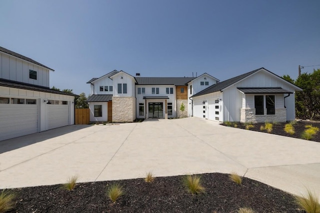 4100 Peak Look Out Dr, Austin, TX 78738 - modern farmhouse style home featuring a standing seam roof, stone siding, a garage, a metal roof, and board and batten siding