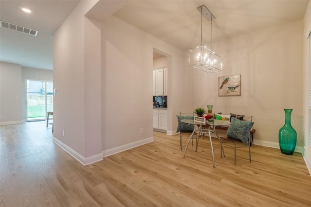 103 Periwinkle Ln, Bastrop, TX 78602 - dining space with light wood finished floors, a chandelier, and recessed lighting