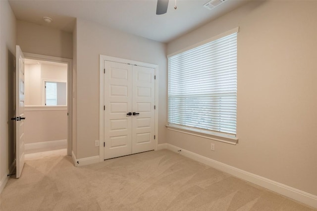 103 Periwinkle Ln, Bastrop, TX 78602 - unfurnished bedroom with light colored carpet, a closet, and ceiling fan
