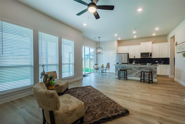 103 Periwinkle Ln, Bastrop, TX 78602 - living room featuring a ceiling fan, light wood-type flooring, and recessed lighting