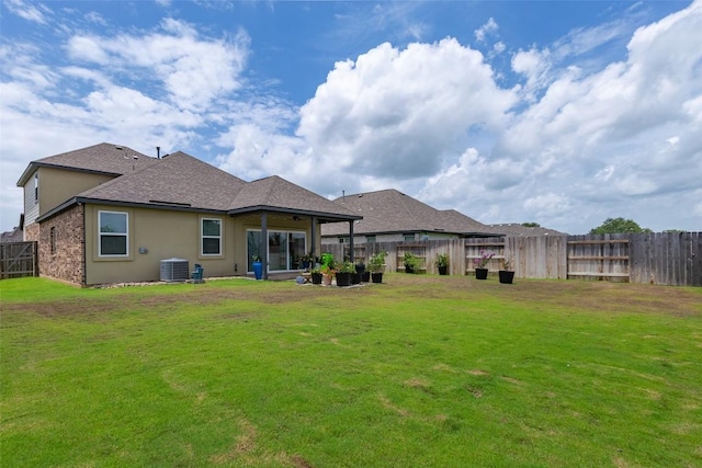 126 Periwinkle Ln, Bastrop, TX 78602 - rear view of property with a fenced backyard, a shingled roof, and stucco siding