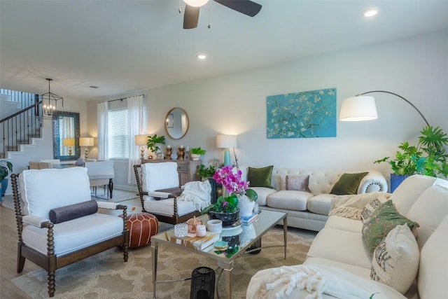 126 Periwinkle Ln, Bastrop, TX 78602 - living area featuring stairway, a chandelier, wood finished floors, recessed lighting, and a ceiling fan