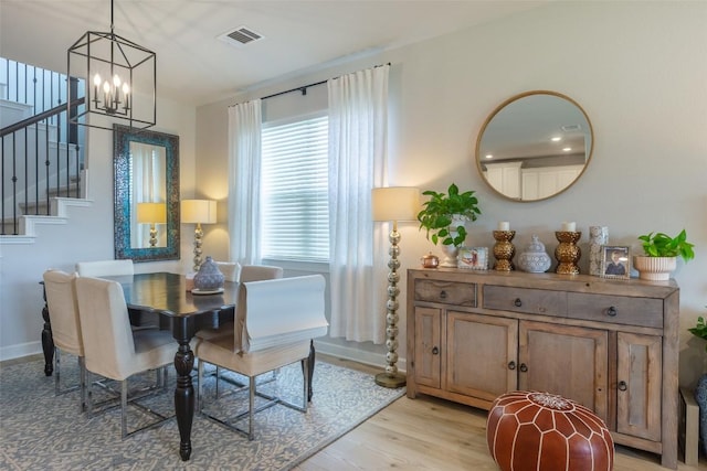126 Periwinkle Ln, Bastrop, TX 78602 - dining area with a chandelier, stairway, and light wood-style flooring