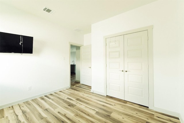 324 Millbrook Blvd, San Marcos, TX 78666 - unfurnished bedroom with light wood finished floors and a closet
