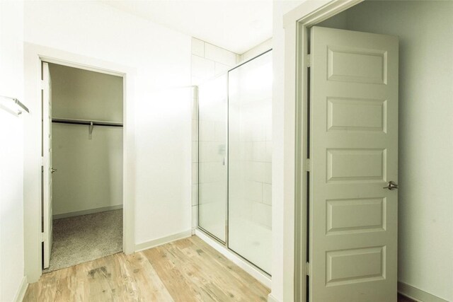 324 Millbrook Blvd, San Marcos, TX 78666 - bathroom featuring a shower stall, wood finished floors, and a spacious closet