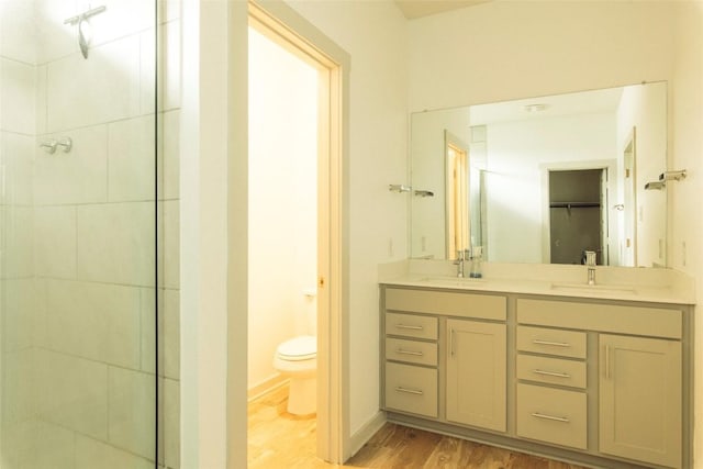 324 Millbrook Blvd, San Marcos, TX 78666 - full bathroom with wood finished floors, a tile shower, and double vanity