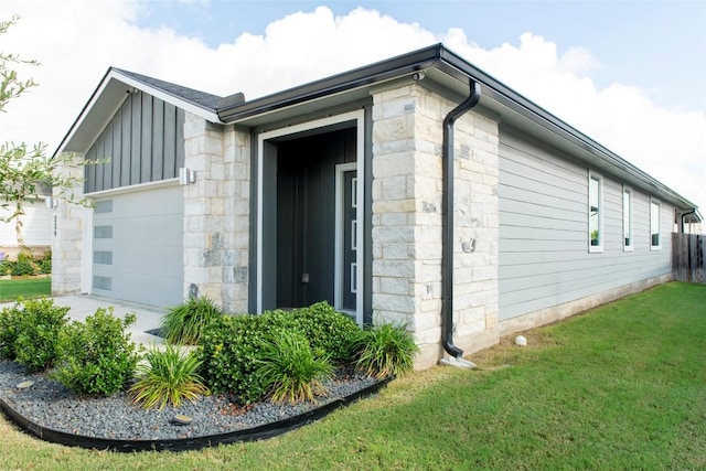324 Millbrook Blvd, San Marcos, TX 78666 - view of side of property featuring a lawn, a garage, stone siding, and board and batten siding
