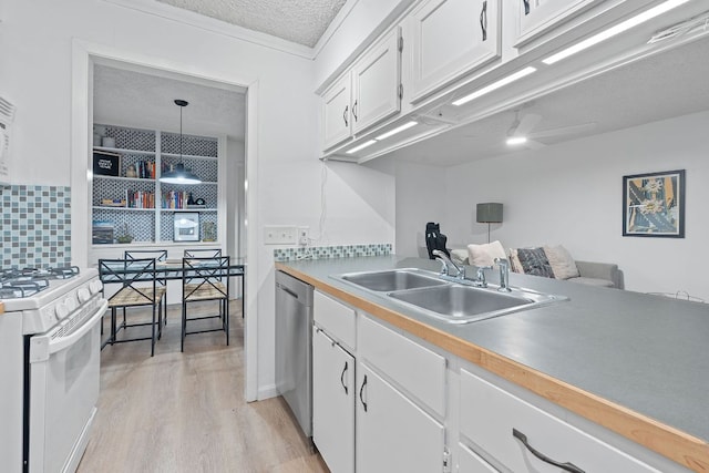 1240 Barton Hills Dr Unit 114, Austin, TX 78704 - kitchen with white range with gas cooktop, dishwasher, white cabinets, light wood finished floors, and a textured ceiling