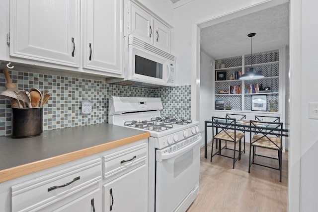 1240 Barton Hills Dr Unit 114, Austin, TX 78704 - kitchen with white appliances, white cabinetry, light wood finished floors, backsplash, and a textured ceiling