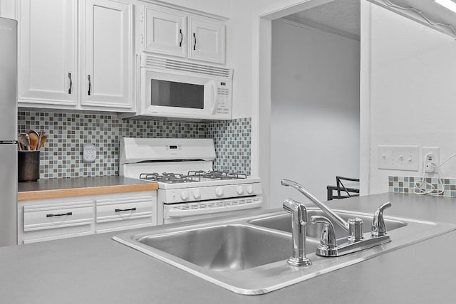 1240 Barton Hills Dr Unit 114, Austin, TX 78704 - kitchen featuring white appliances, white cabinets, decorative backsplash, and light countertops