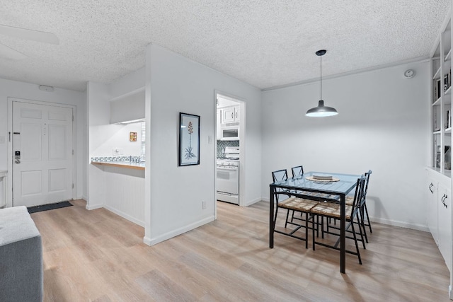 1240 Barton Hills Dr Unit 114, Austin, TX 78704 - dining space with wood finished floors and a textured ceiling