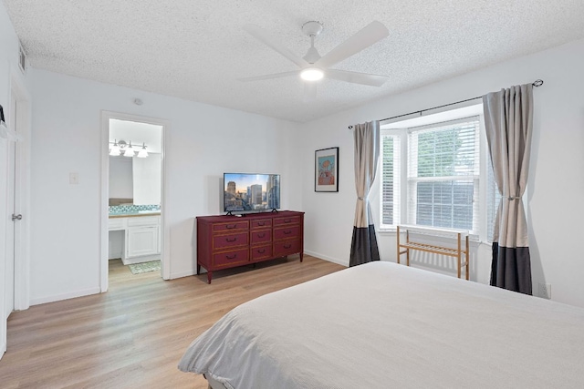 1240 Barton Hills Dr Unit 114, Austin, TX 78704 - bedroom featuring light wood-type flooring, a textured ceiling, ensuite bath, and ceiling fan