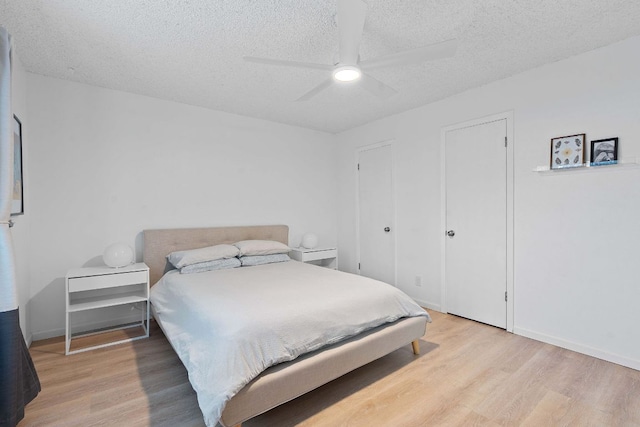 1240 Barton Hills Dr Unit 114, Austin, TX 78704 - bedroom featuring light wood finished floors, a textured ceiling, and ceiling fan