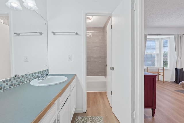 1240 Barton Hills Dr Unit 114, Austin, TX 78704 - bathroom with wood finished floors, vanity, and shower / tub combination