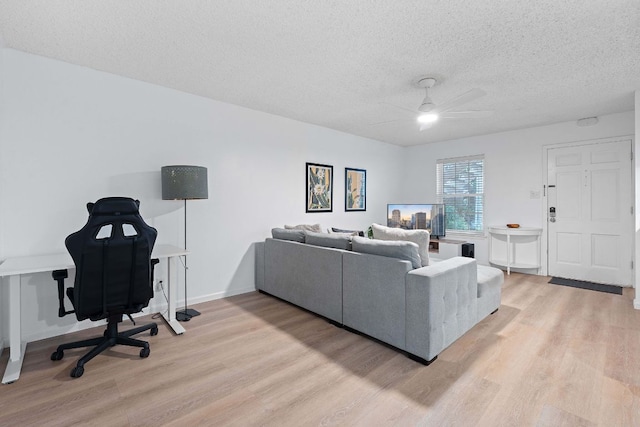 1240 Barton Hills Dr Unit 114, Austin, TX 78704 - living area featuring light wood finished floors, a textured ceiling, and ceiling fan