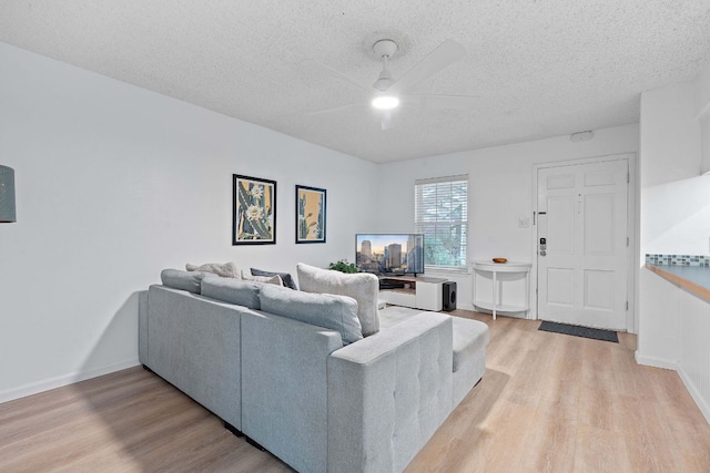 1240 Barton Hills Dr Unit 114, Austin, TX 78704 - living area with a ceiling fan, light wood-style floors, and a textured ceiling