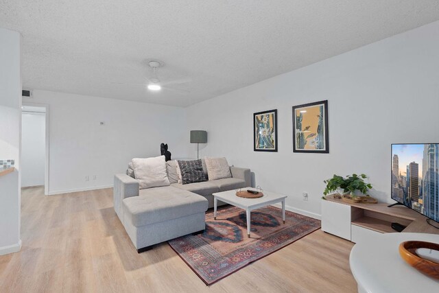 1240 Barton Hills Dr Unit 114, Austin, TX 78704 - living area with light wood-type flooring, a ceiling fan, and a textured ceiling