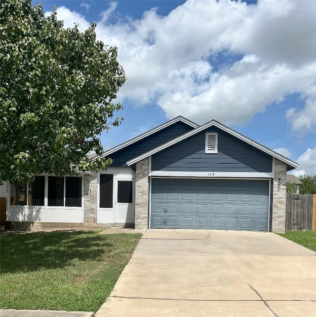 108 Bexar Forest Cv, Elgin, TX 78621 - single story home with a garage, concrete driveway, and stone siding