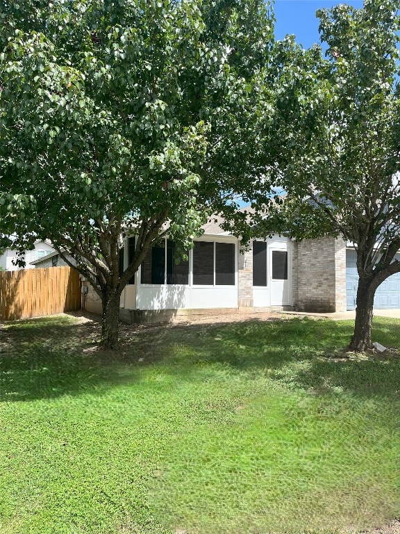 108 Bexar Forest Cv, Elgin, TX 78621 - back of house featuring a sunroom