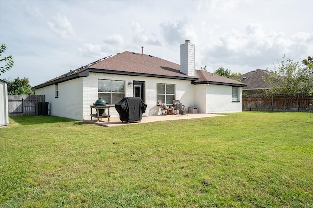 1410 Sherry Dr, Taylor, TX 76574 - back of property featuring brick siding, a patio area, a fenced backyard, a chimney, and a shingled roof