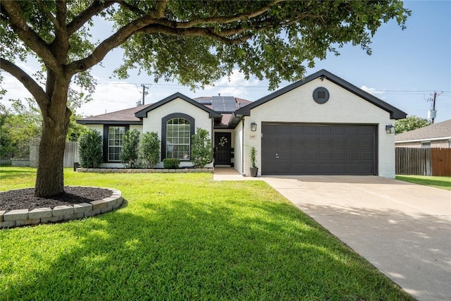 1410 Sherry Dr, Taylor, TX 76574 - single story home featuring solar panels, a garage, and concrete driveway
