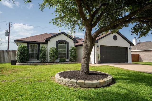 1410 Sherry Dr, Taylor, TX 76574 - ranch-style home featuring roof mounted solar panels, an attached garage, driveway, roof with shingles, and brick siding