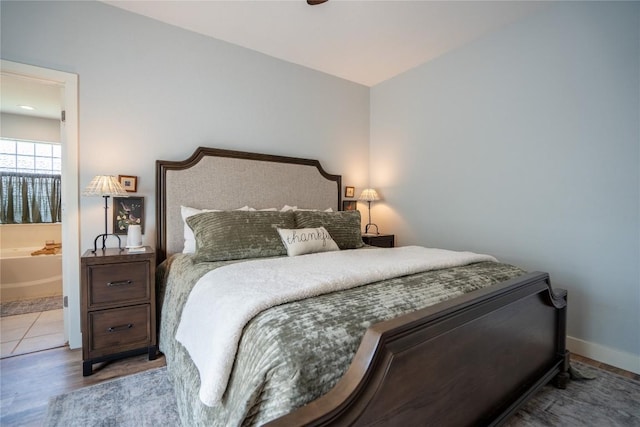 1410 Sherry Dr, Taylor, TX 76574 - bedroom featuring wood finished floors and ensuite bath