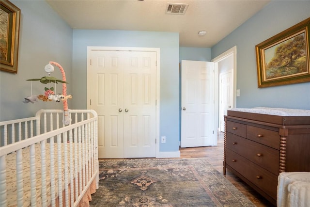 1410 Sherry Dr, Taylor, TX 76574 - bedroom with wood finished floors, a closet, and a nursery area